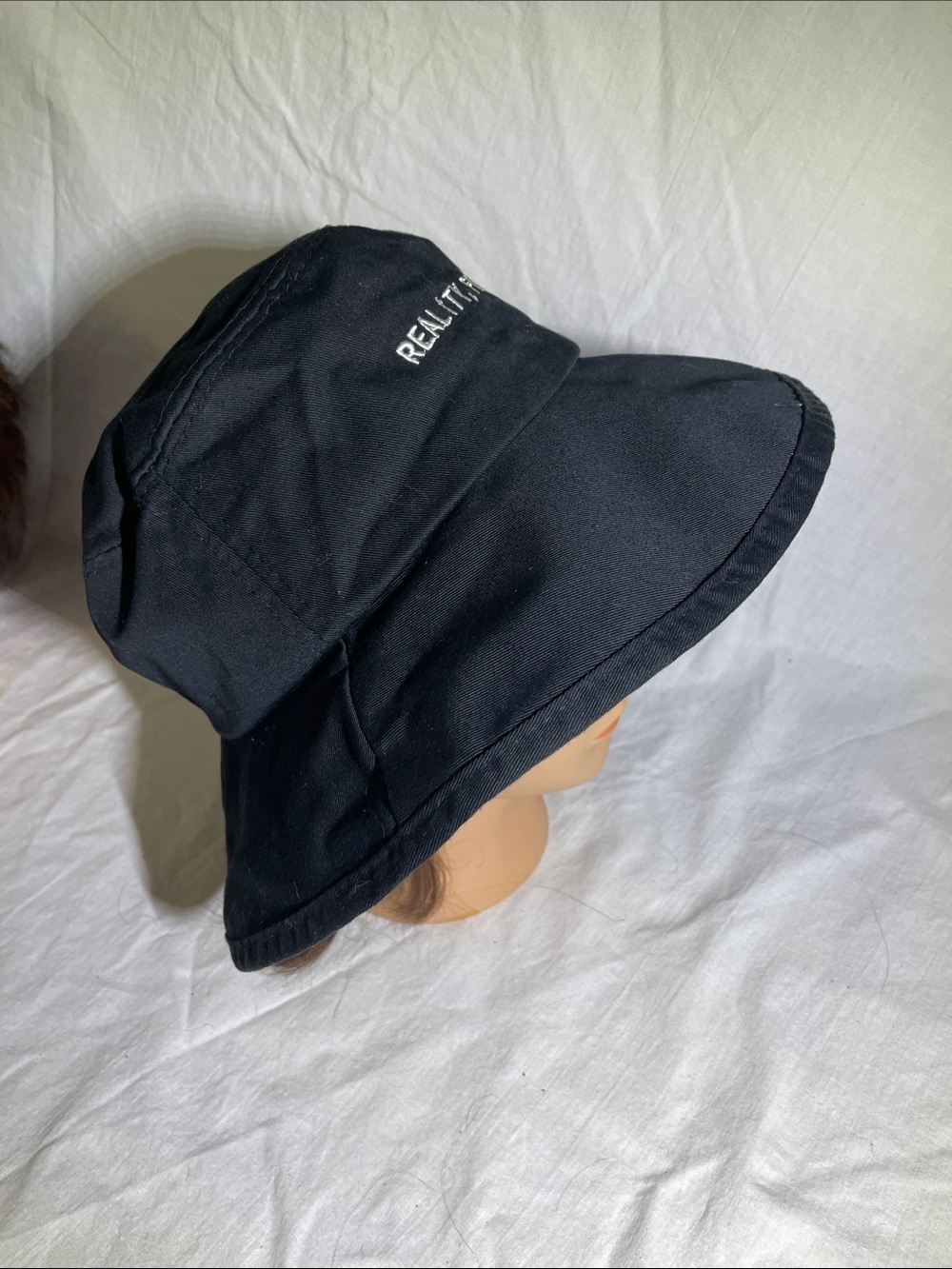Black Bucket Hat with White Text “Reality, Forget The Past”
